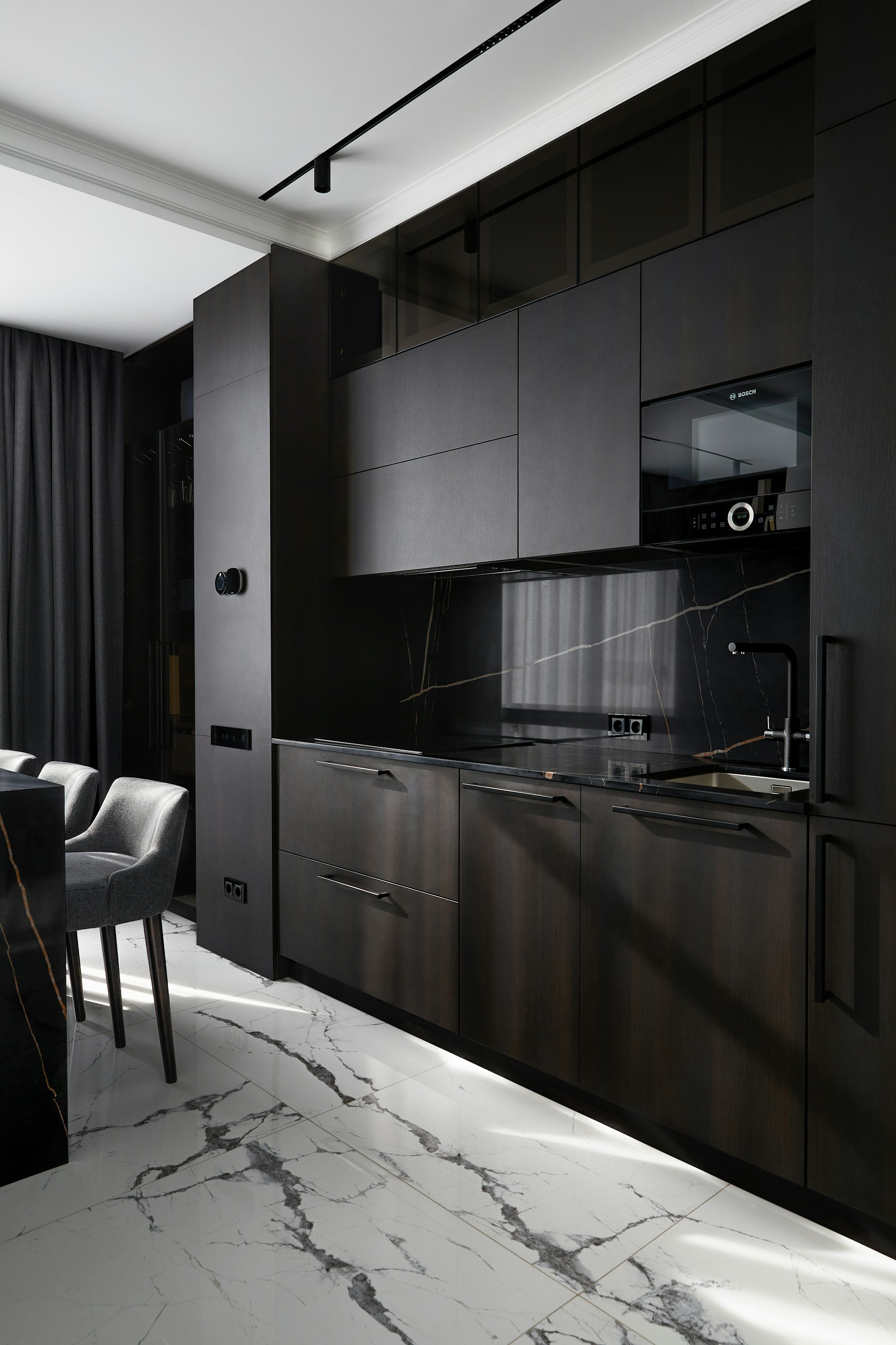 Dark contemporary kitchen with marble surfaces